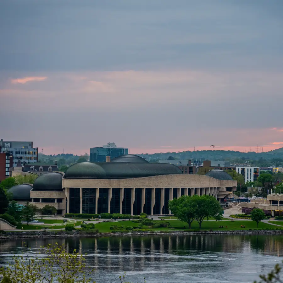 Canadian Museum of History in Gatineau, Quebec, viewed across the Ottawa River at sunset.