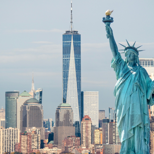 Statue of Liberty overlooking the New York City skyline, with One World Trade Center rising in the background.